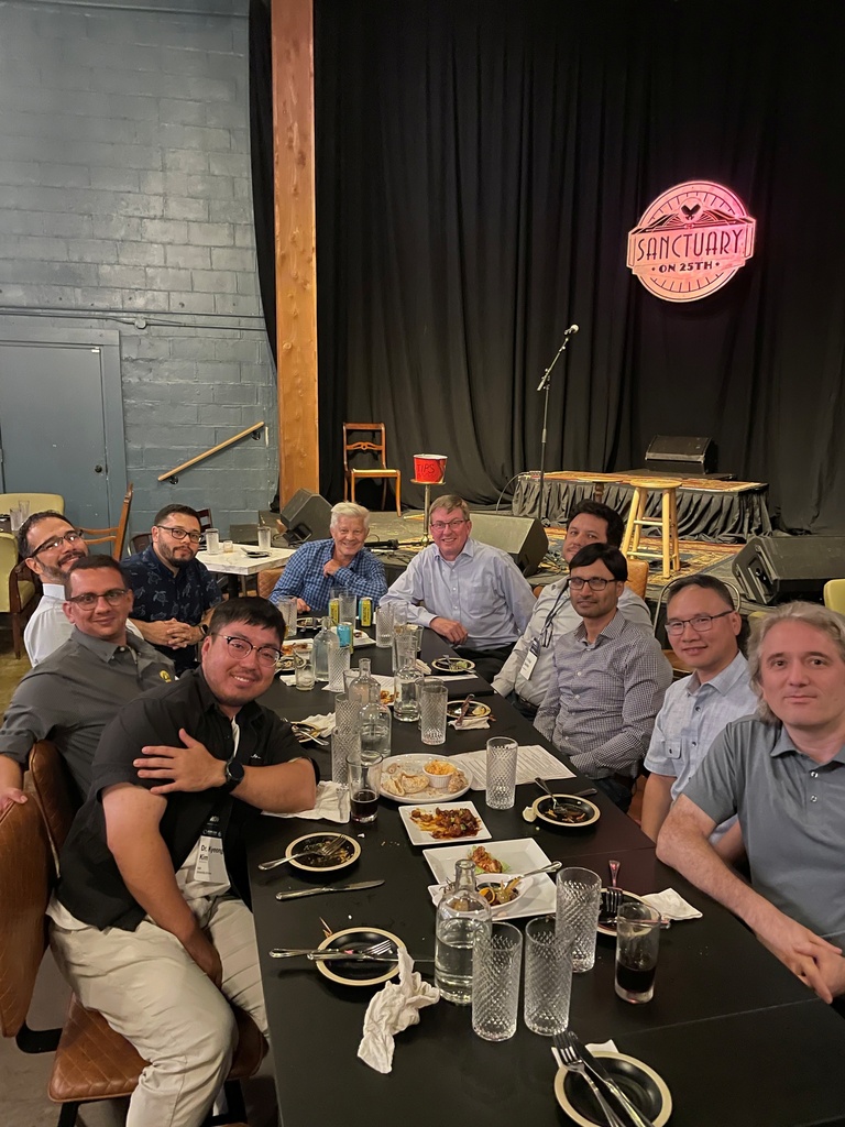 Alumni from IIHR and CIROH sit at a table, talking and eating.