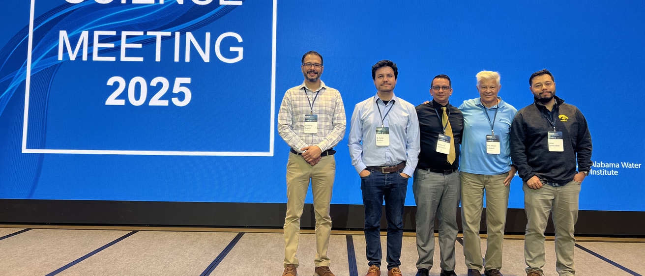 CIROH researchers stand on the stage and smile, at the CIROH 2025 Science meeting